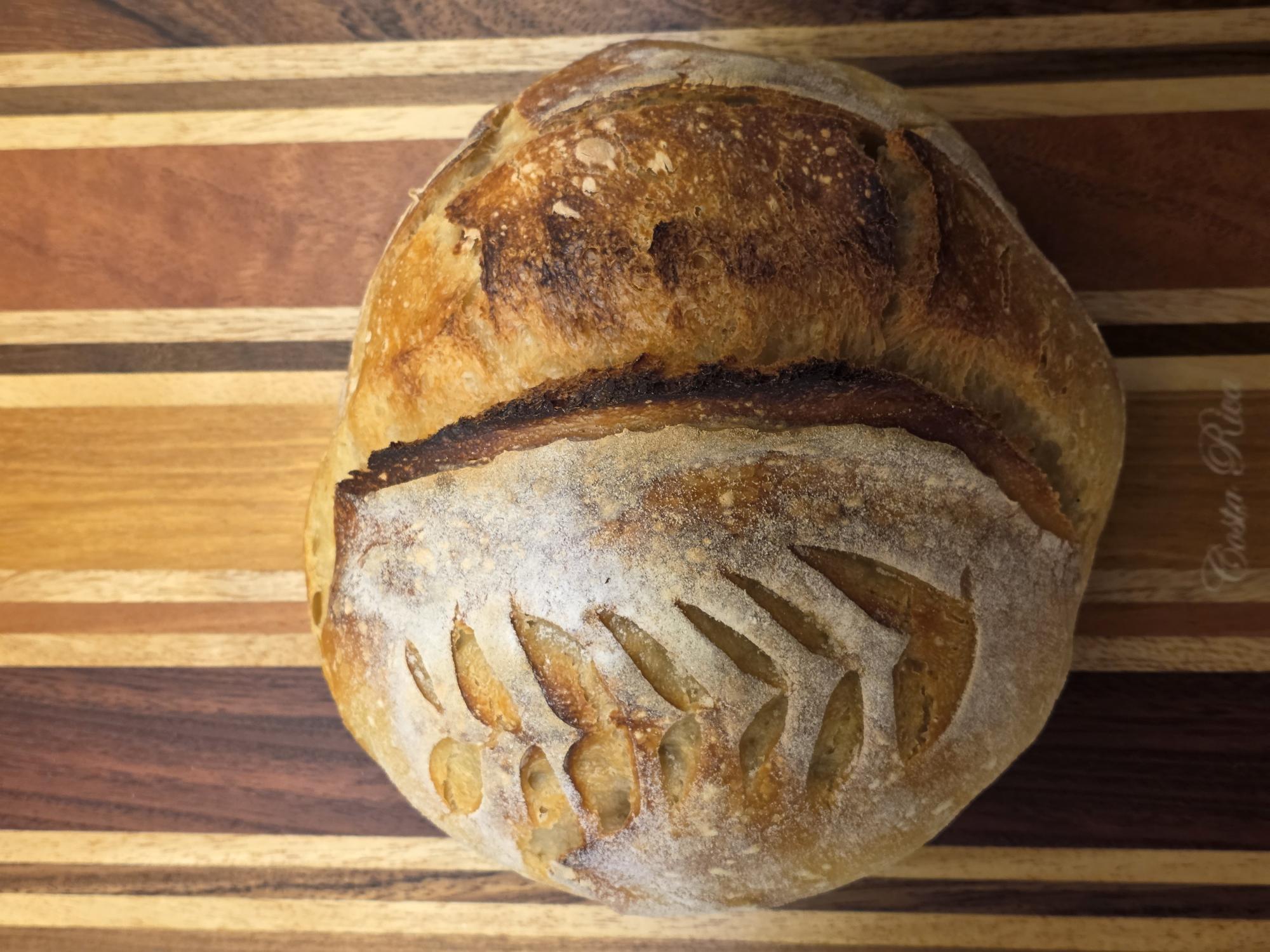Freshly baked artisan loaf with a decorative score